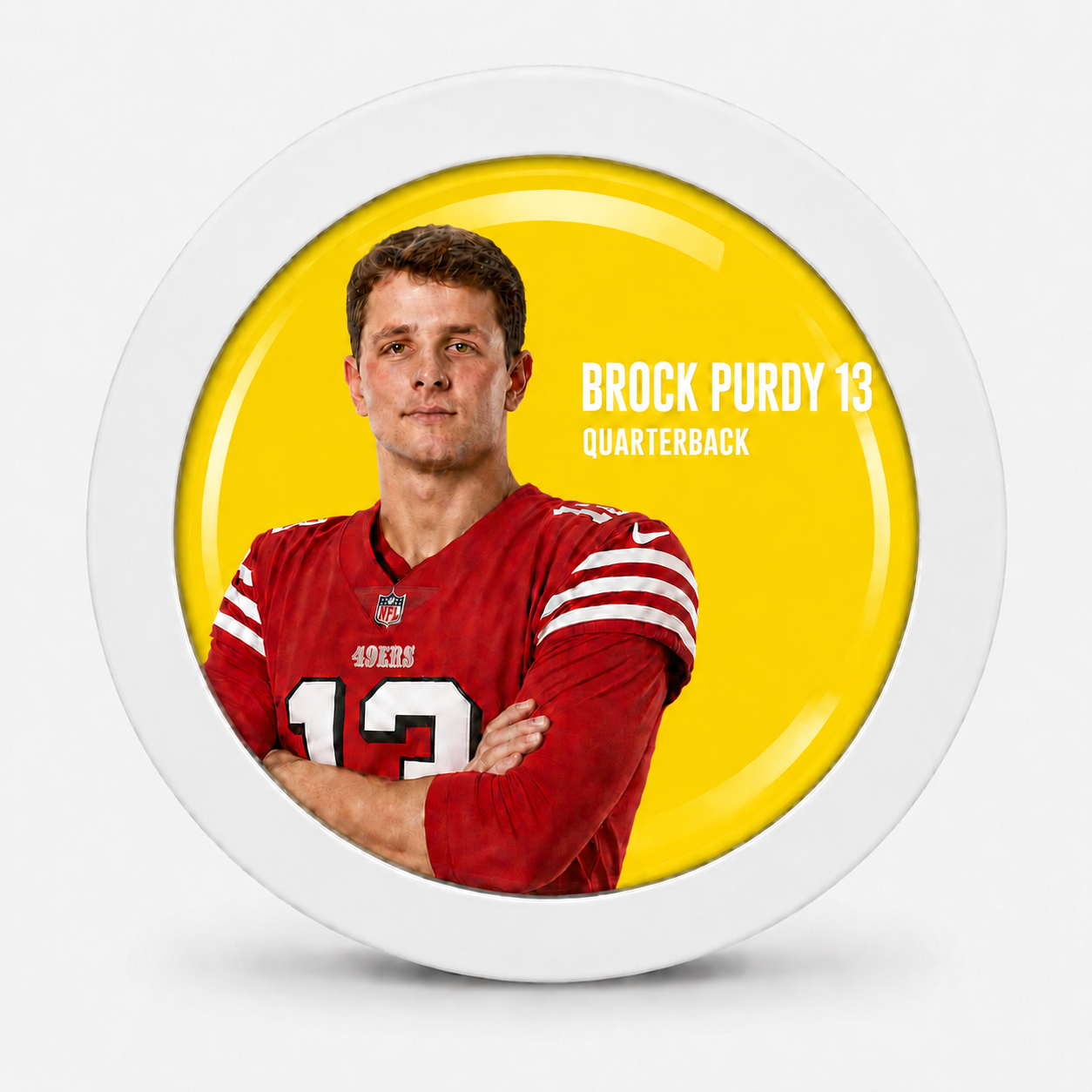 Rodela badge with Brock Purdy in a red 49ers jersey on a yellow background